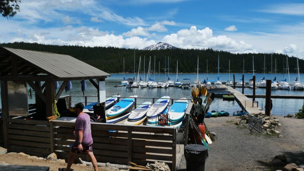 The watercraft rentals, dock, and mountain views from Elk Lake Resort.