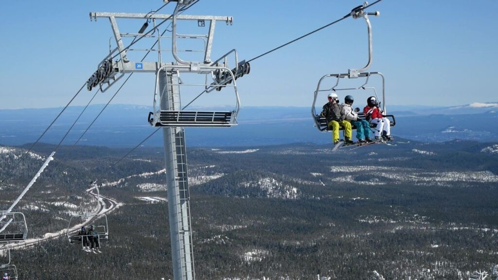 Skiers riding a chairlift at Mt. Bachelor.