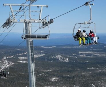 Skiers riding a chairlift at Mt. Bachelor.