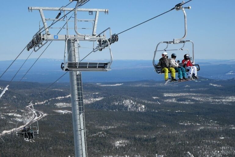 Skiers riding a chairlift at Mt. Bachelor.