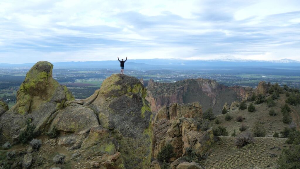 A man hiking at Smith Rock State Park on the Burma Road Loop hike.