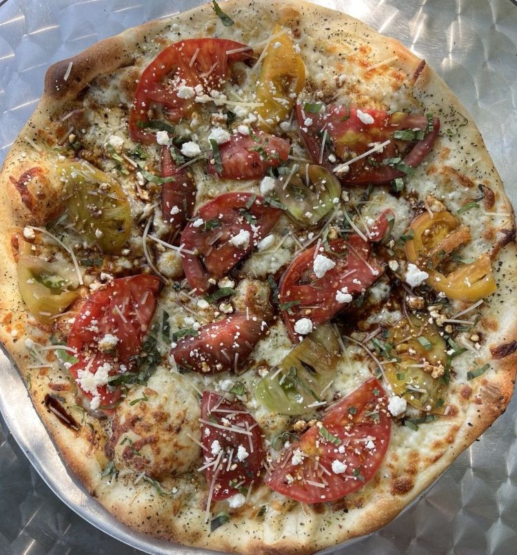 A seasonal tomato pizza at Pizza Mondo, one of the best pizzas in Bend Oregon.