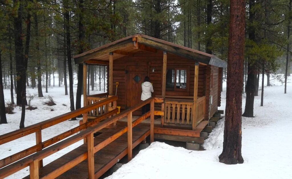 Abby going into a cabin at La Pine State Park during winter.