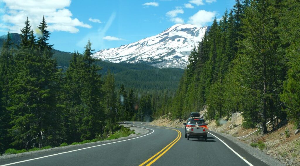 A car driving on the Cascade Lakes Scenic Byway.