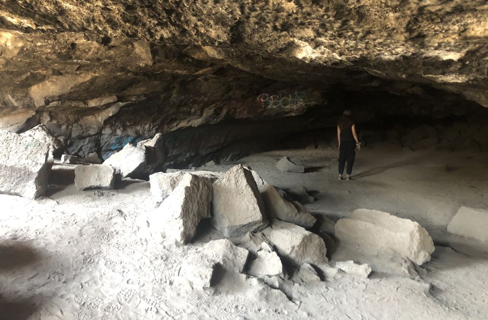 A person exploring the Redmond Caves in Central Oregon.
