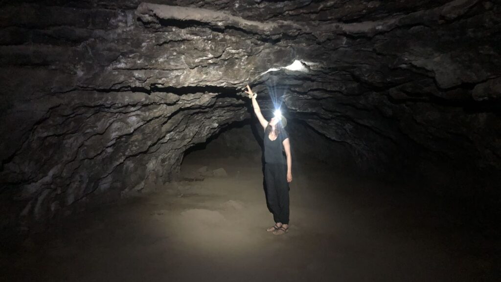 A visitor exploring one of the Redmond Caves