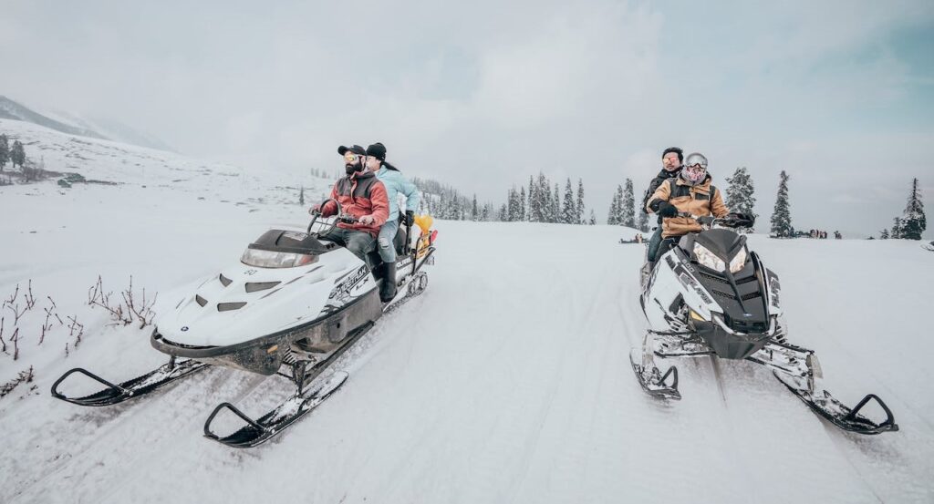 Riders on snowmobiles.