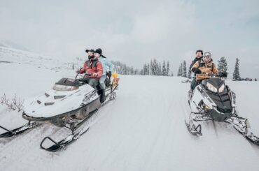 Riders on snowmobiles.