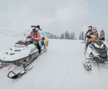 Riders on snowmobiles.