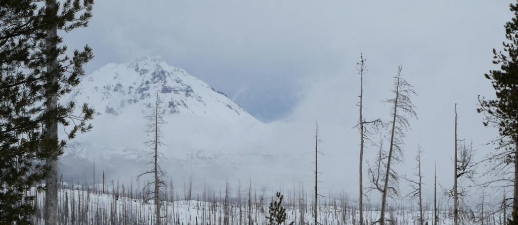 A partially obscured view of South Sister from the warming hut at Three Creek Sno Park.