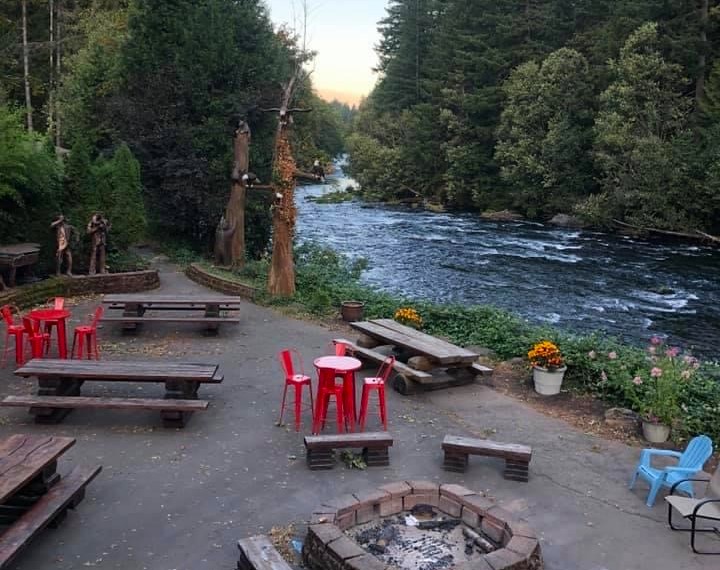 A sitting area by the river at Belknap Hot Springs.