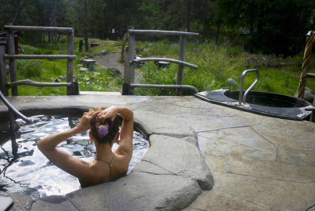 A person soaking in the hot spring pools at Breitenbush.