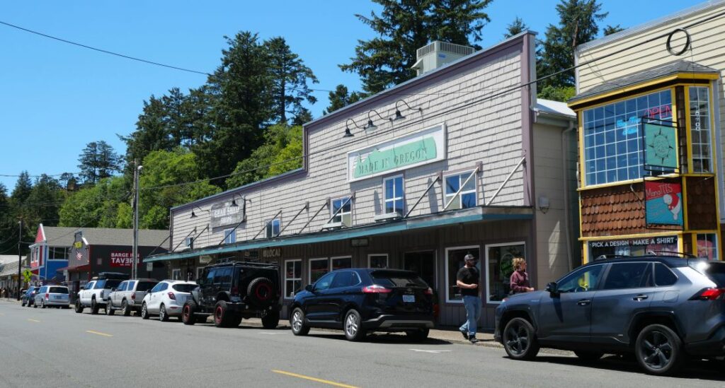 Visitors walk in front of shops in the Newport Historic Bayfront area.