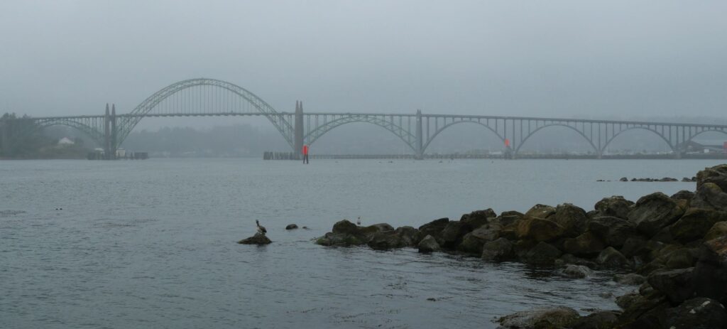 Views of the Yaquina Bay Bridge from South Beach State Park on a cloudy day.