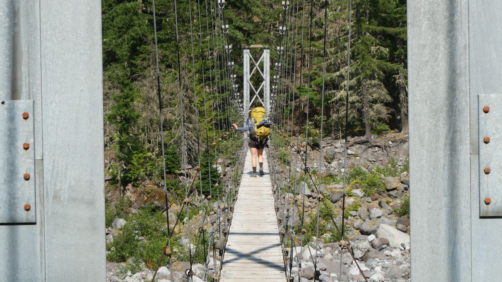 Abby crossing one of the two suspension bridges on the Wonderland Trail.