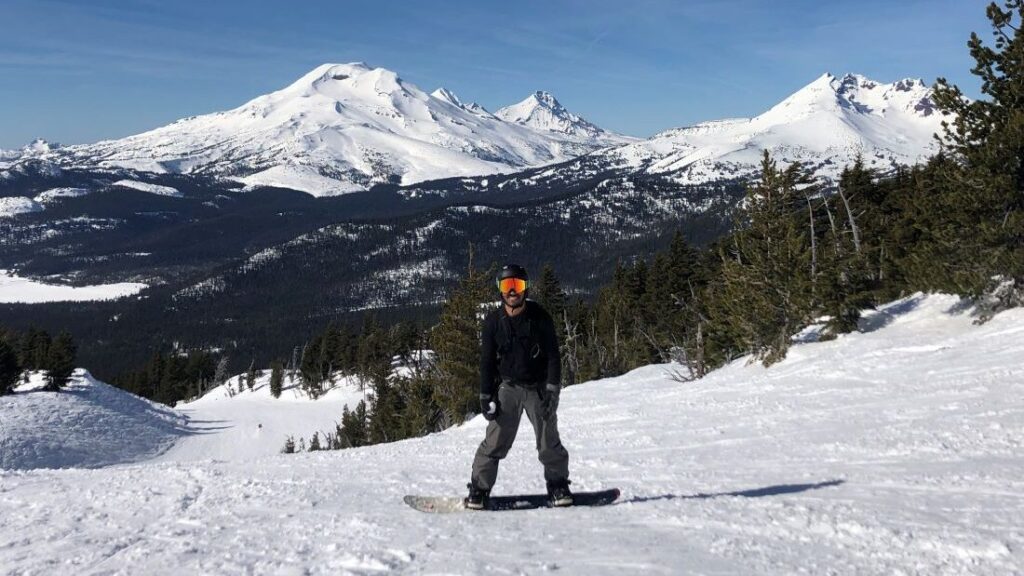 A snowboarder enjoys some blue runs near the Outback lift on a sunny day.