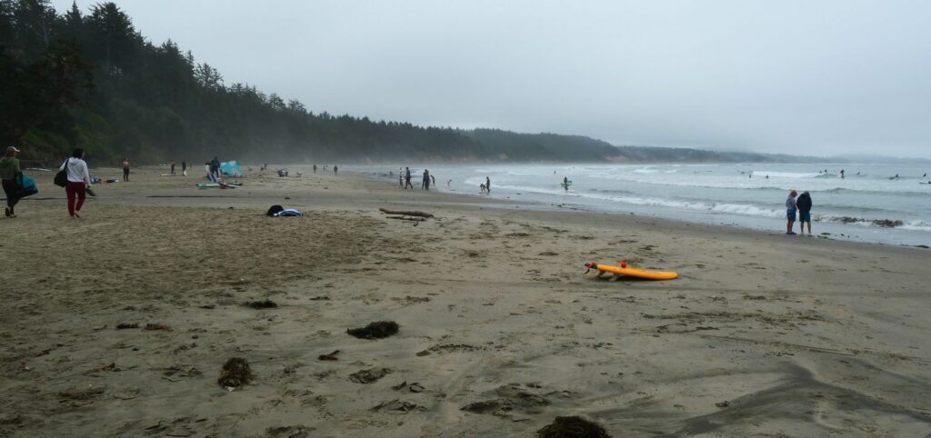 Views looking south along Otter Rock Beach on a busy but cloudy day.