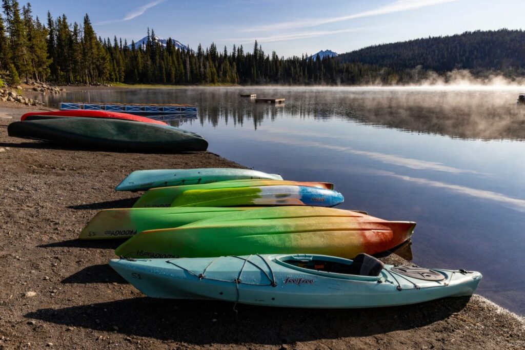 Kayaks along the shoreline of Elk Lake in Oregon.