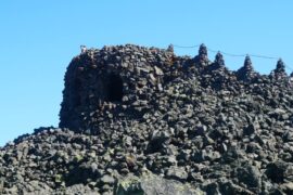A visitor gazing out from the top of the Dee Wright Observatory in Oregon.